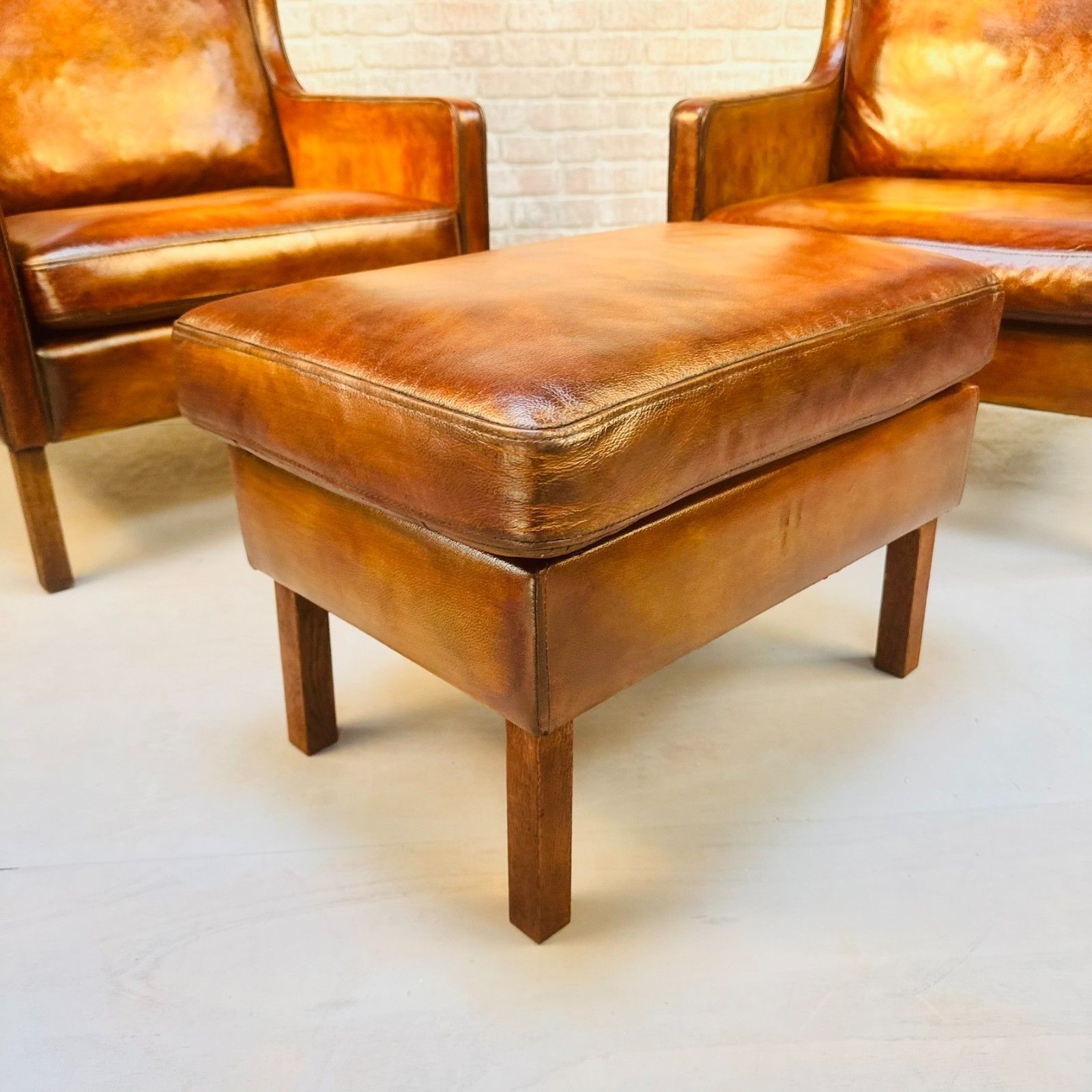 photo vinterior Pair Vintage Danish Wingback Chairs & Footstool Tan Leather Lounge Set