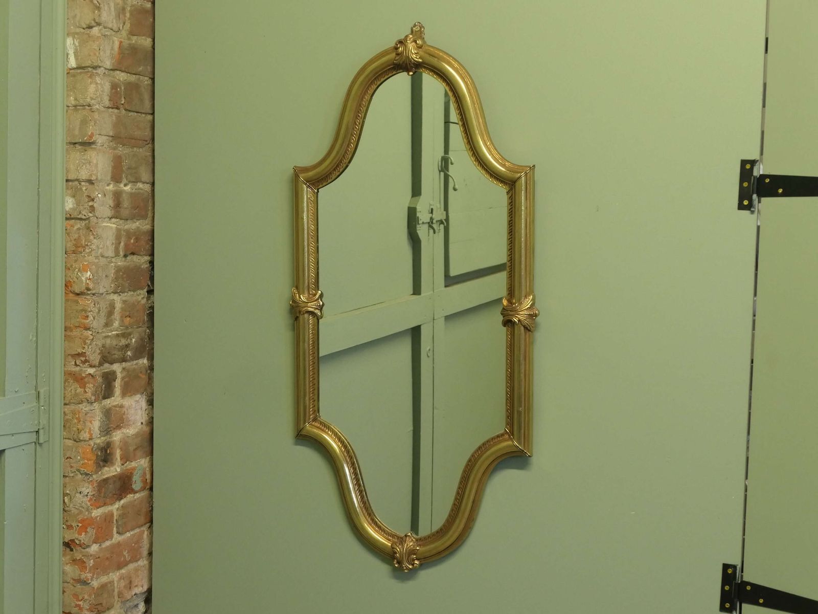 A Long Shaped Oval Brass Wall Mirror The Mirror Has A Decorative Acanthus Leaf Motif Aro photo 696.0