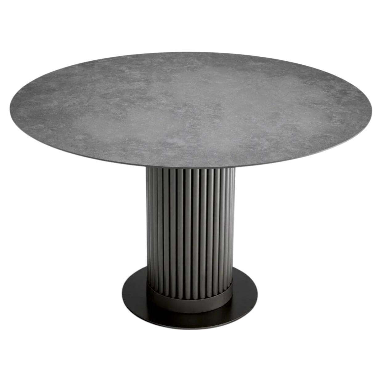 Round Outdoor Dining Table With Bronze Finish And Grey Ceramic Top.