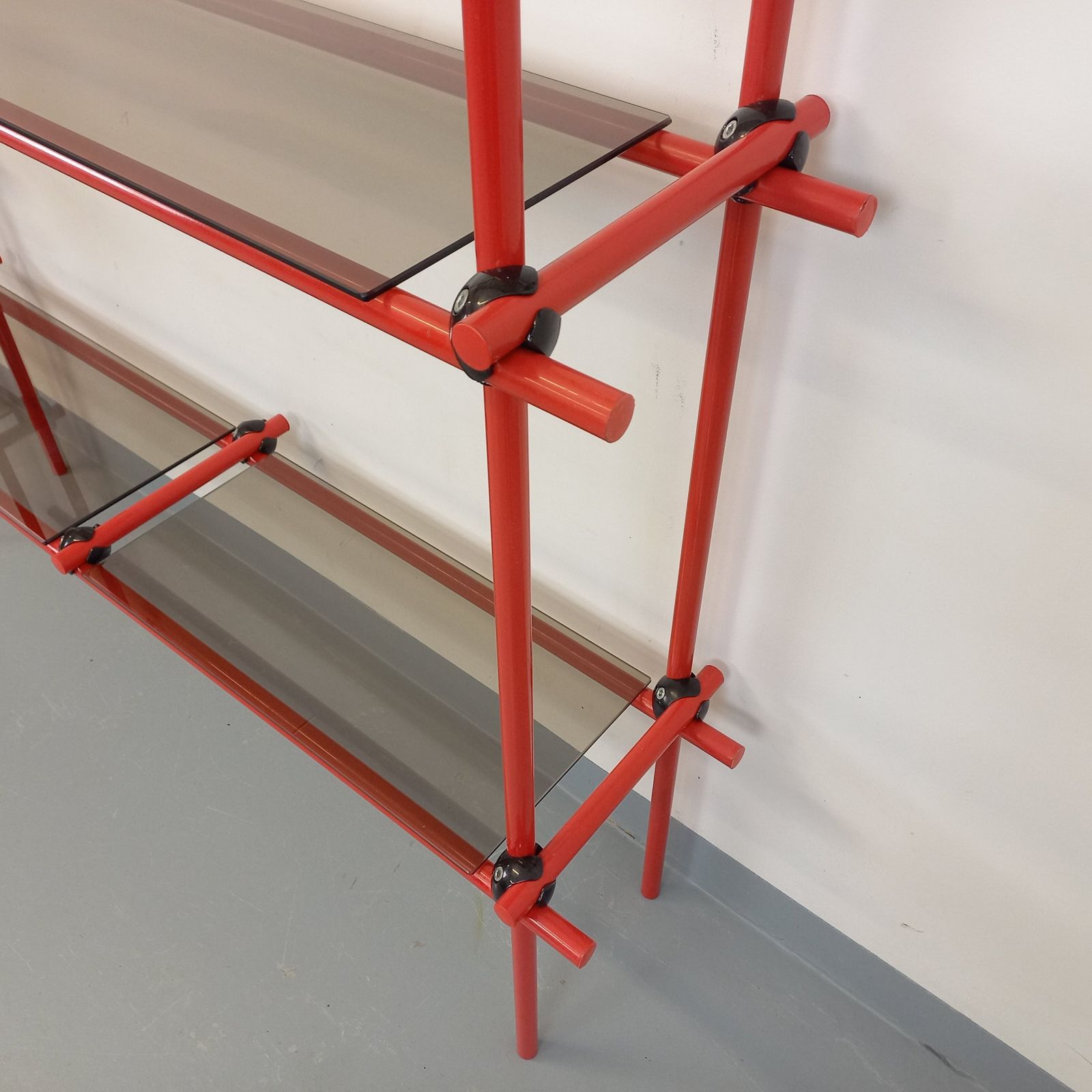 photo furniture Italiaanse boekenkast in Bauhaus-stijl, rood metaal en rookglas