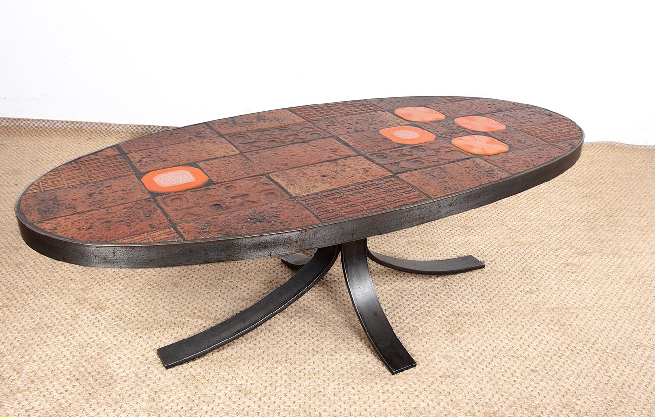 photo furniture Table basse en pierre de lave, céramique et acier, par Jean Jaffeux, 1960.