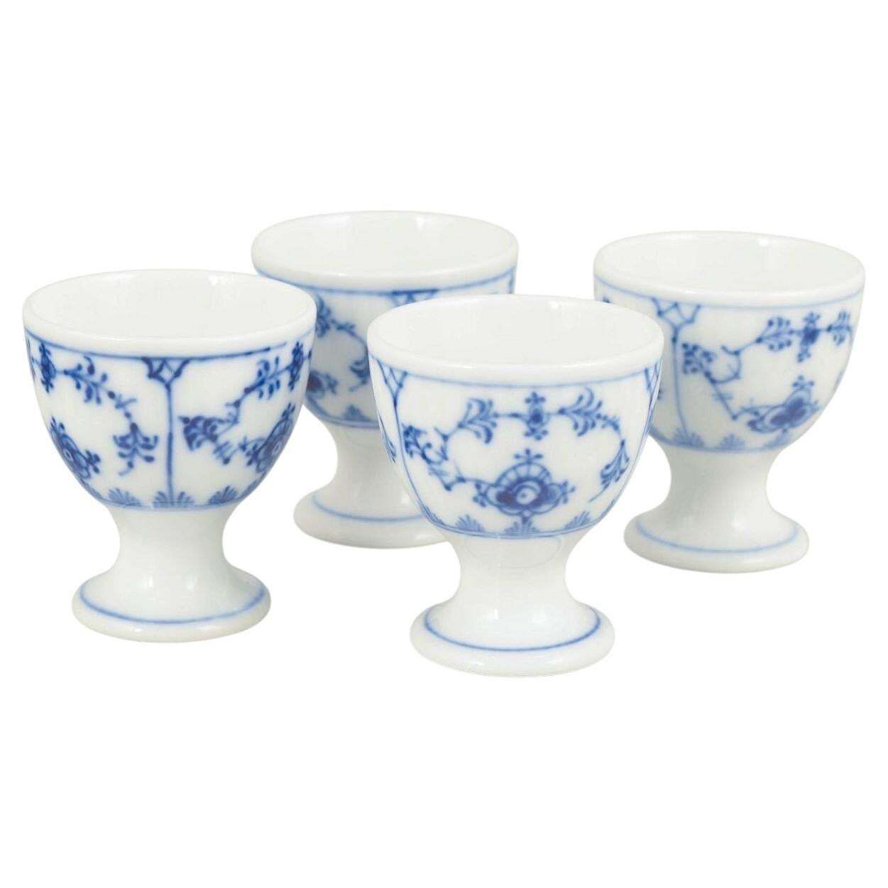 Royal Copenhagen. Ensemble de quatre coquetiers, Blue Fluted Plain. Années 1920.