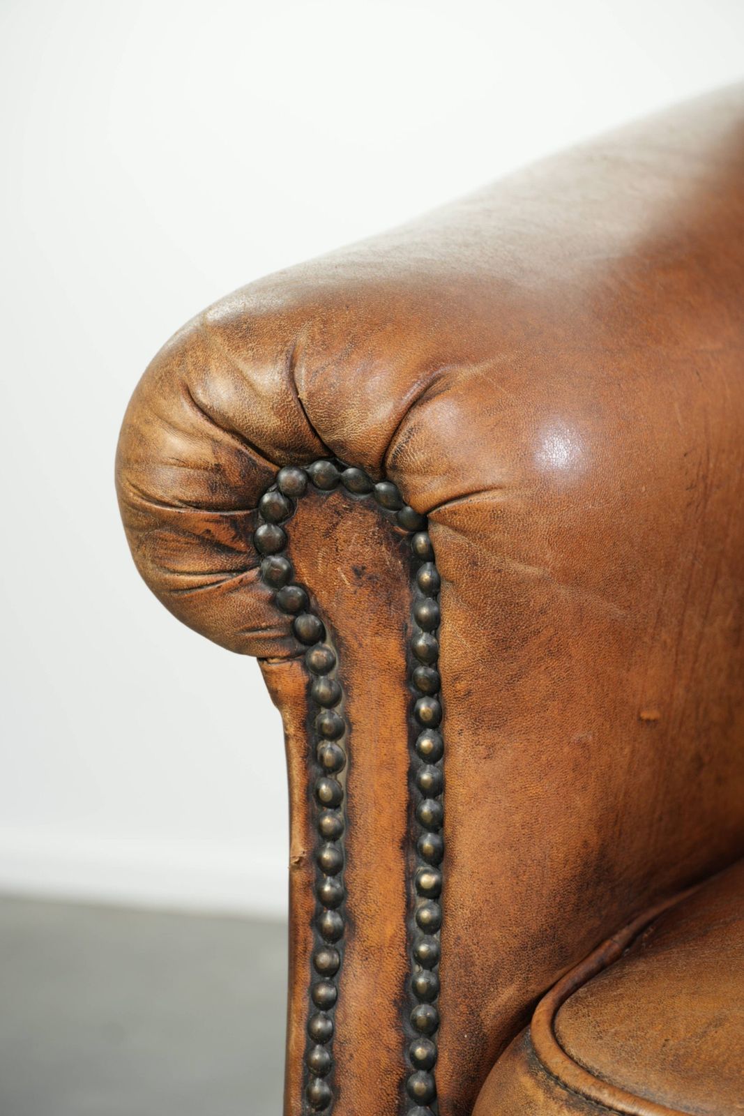 photo for sale Comfortable, Characterful Sheepskin Armchair Finished With Decorative Nails And A Beautiful Patina