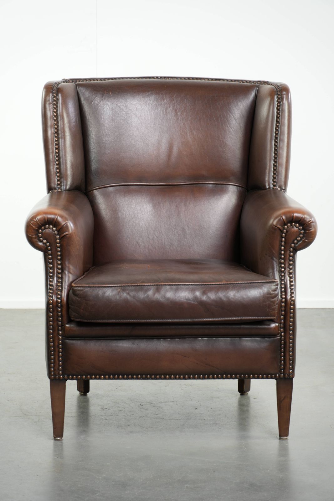 Beautiful, Subtle Sheepskin Wing Armchair With A Deep Cognac Color And A Comfortable Seat. photo furniture