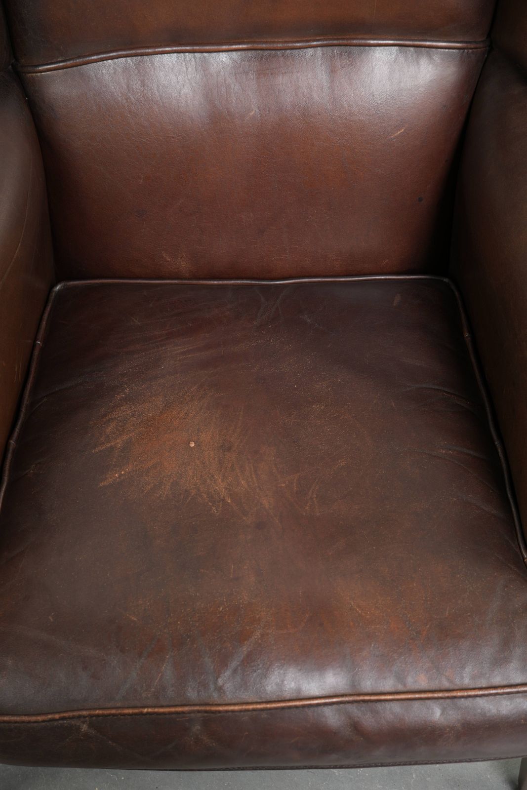 Beautiful, Subtle Sheepskin Wing Armchair With A Deep Cognac Color And A Comfortable Seat. photo vinterior
