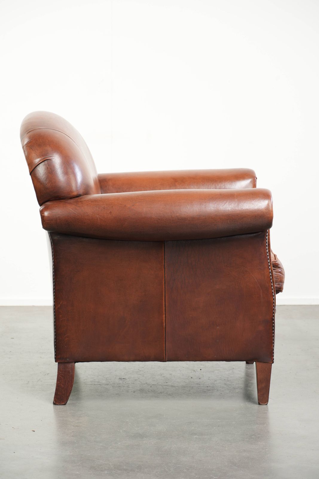 Vintage Sheep Leather Armchair With A Comfortable Seat And Finished With Ornamental Nails photo for sale