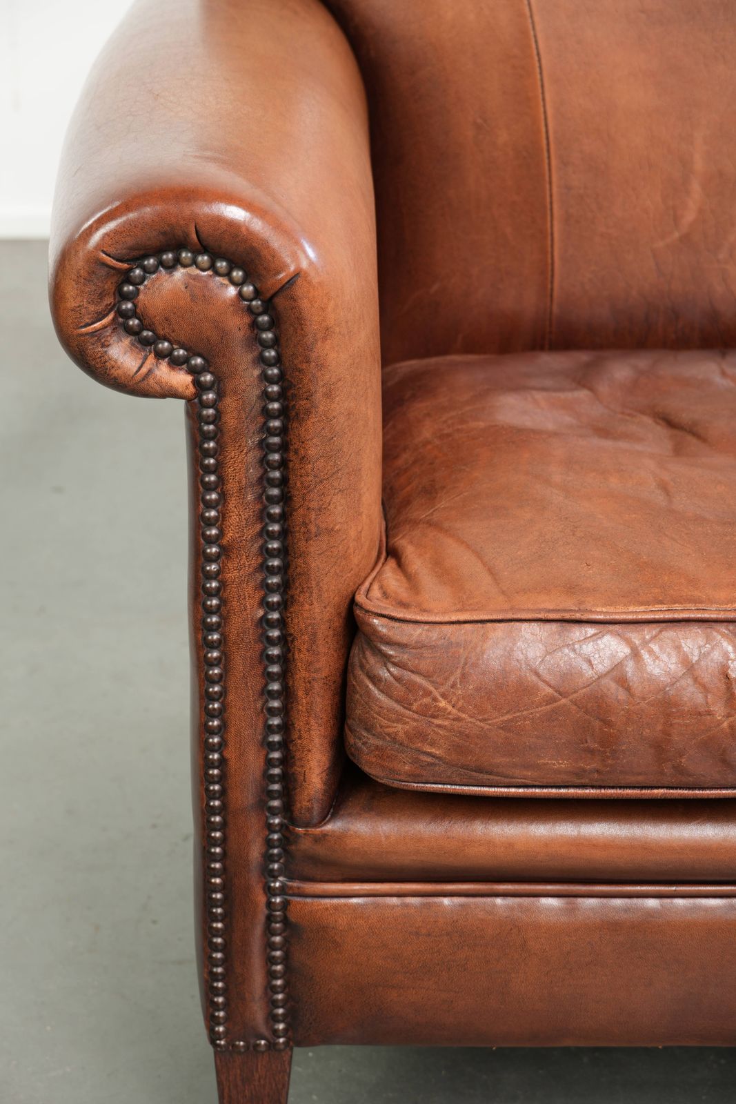 photo furniture Vintage Sheep Leather Armchair With A Comfortable Seat And Finished With Ornamental Nails