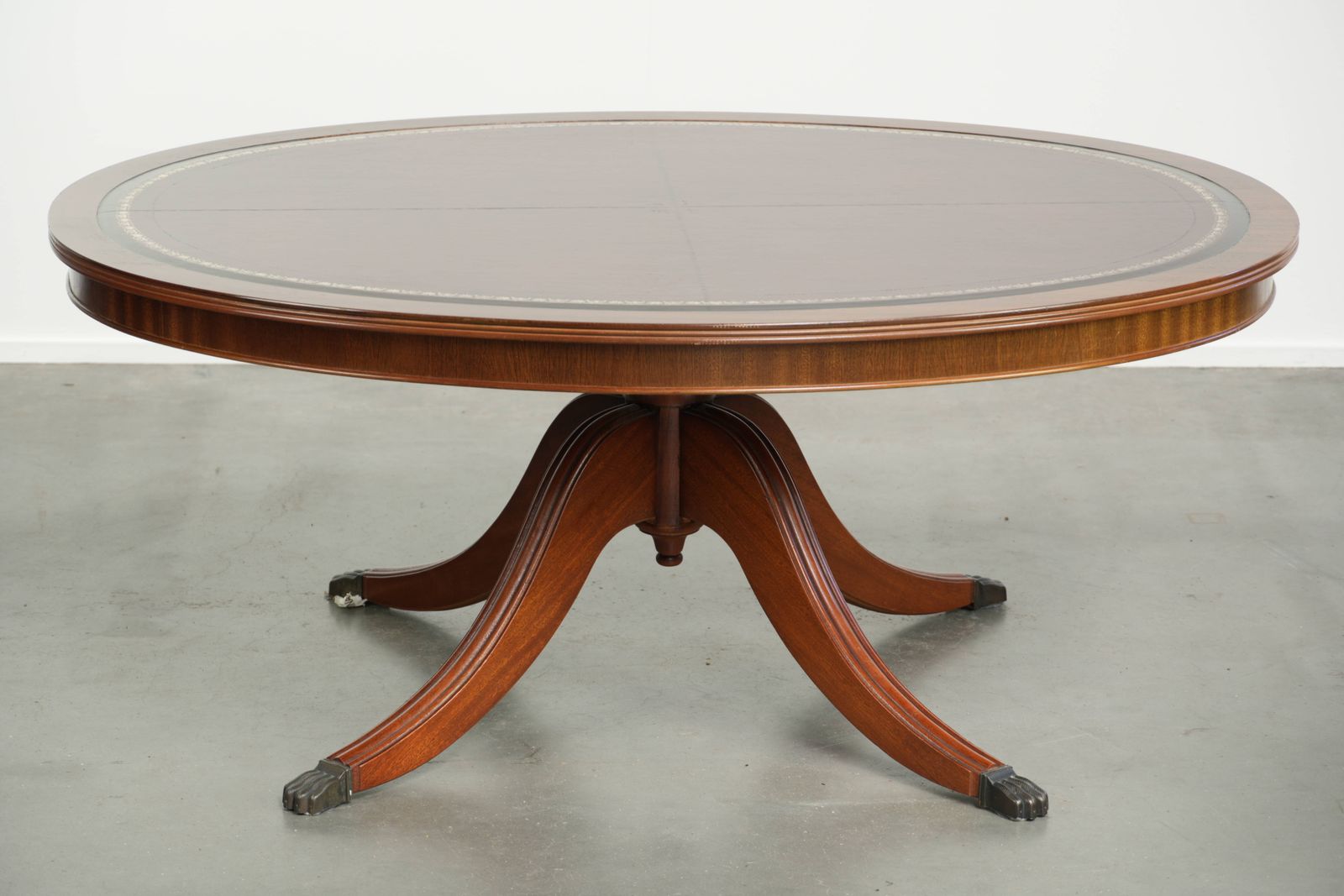 Elegant Oval Coffee Table With A Red Leather Top In English Style With Beautiful Details From The 20th Century photo furniture