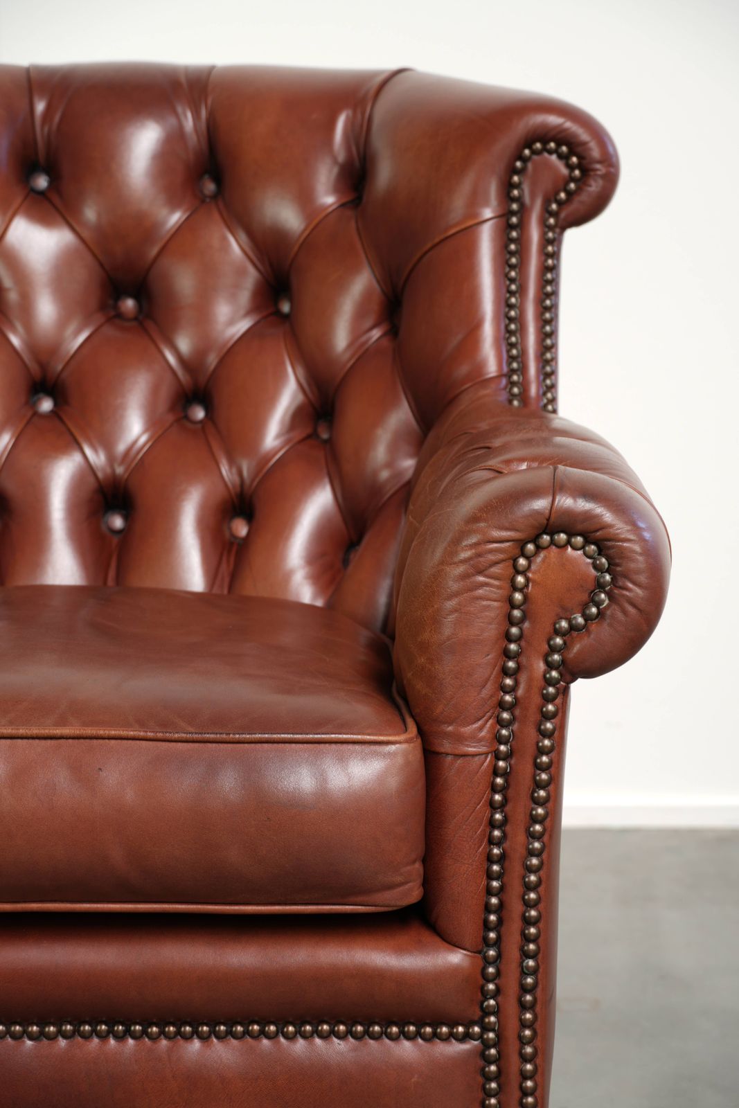 photo furniture Very High Quality Cognac Colored Cowhide Chesterfield Armchair In English Style With A Timeless Design