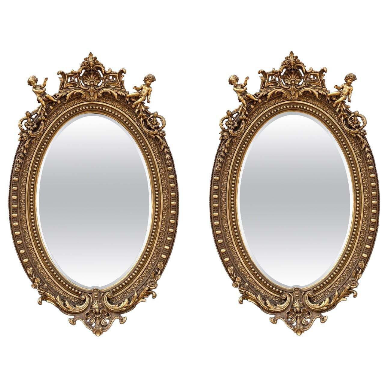 Paire de miroirs ovales en bois doré de style baroque, avec angelots, 92 pouces