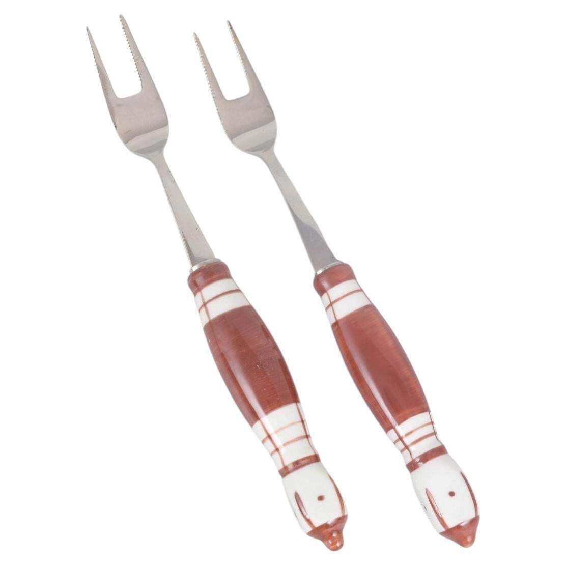 Bjørn Wiinblad, Rosenthal. Pair Of Meat Forks In Stainless Steel And Porcelain.