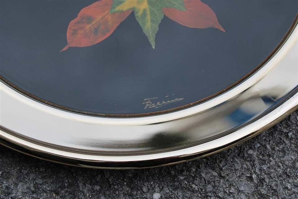 Round Tray In Golden Brass With Black Background And Real Leaves Made In Italy photo for sale