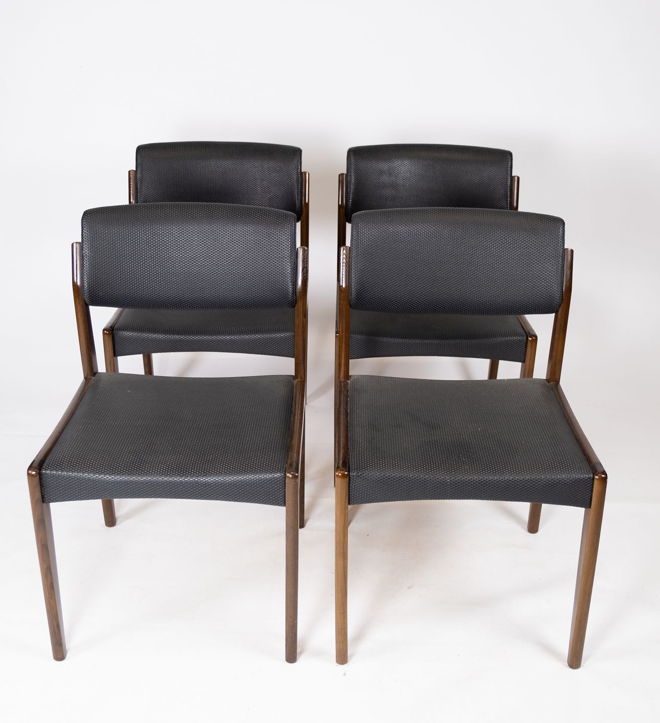 Set Of Four Dining Chairs Of Black Upholstery And Dark Wood Of Danish Design From The 1960s.