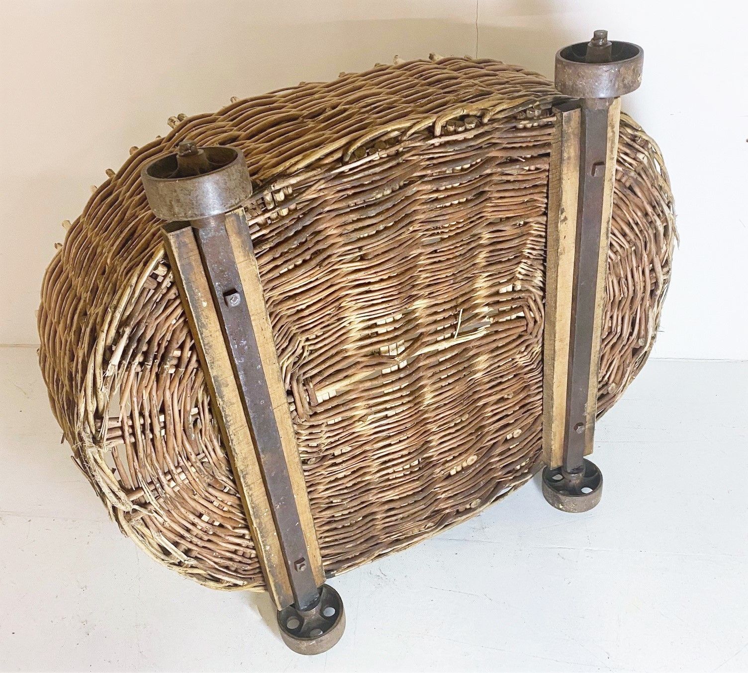 photo furniture Large Wicker Dog Bed Or Log Basket On Cast Iron Wheels