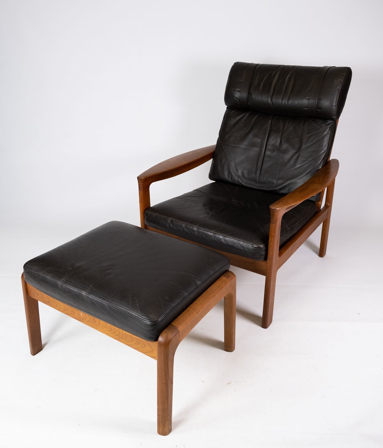 Armchair And Stool In Teak Upholstered With Black Leather Designed By Arne Vodder And Manufactured By Komfort In The 1960s.