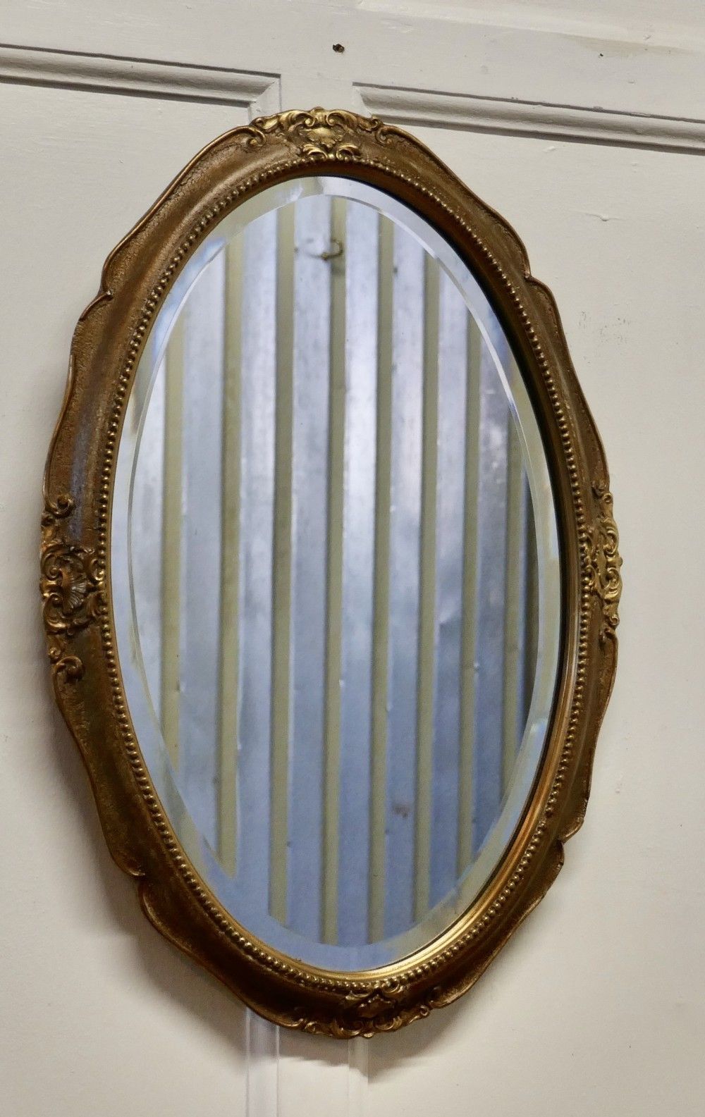 An Art Deco Oval Gilt Wall Mirror