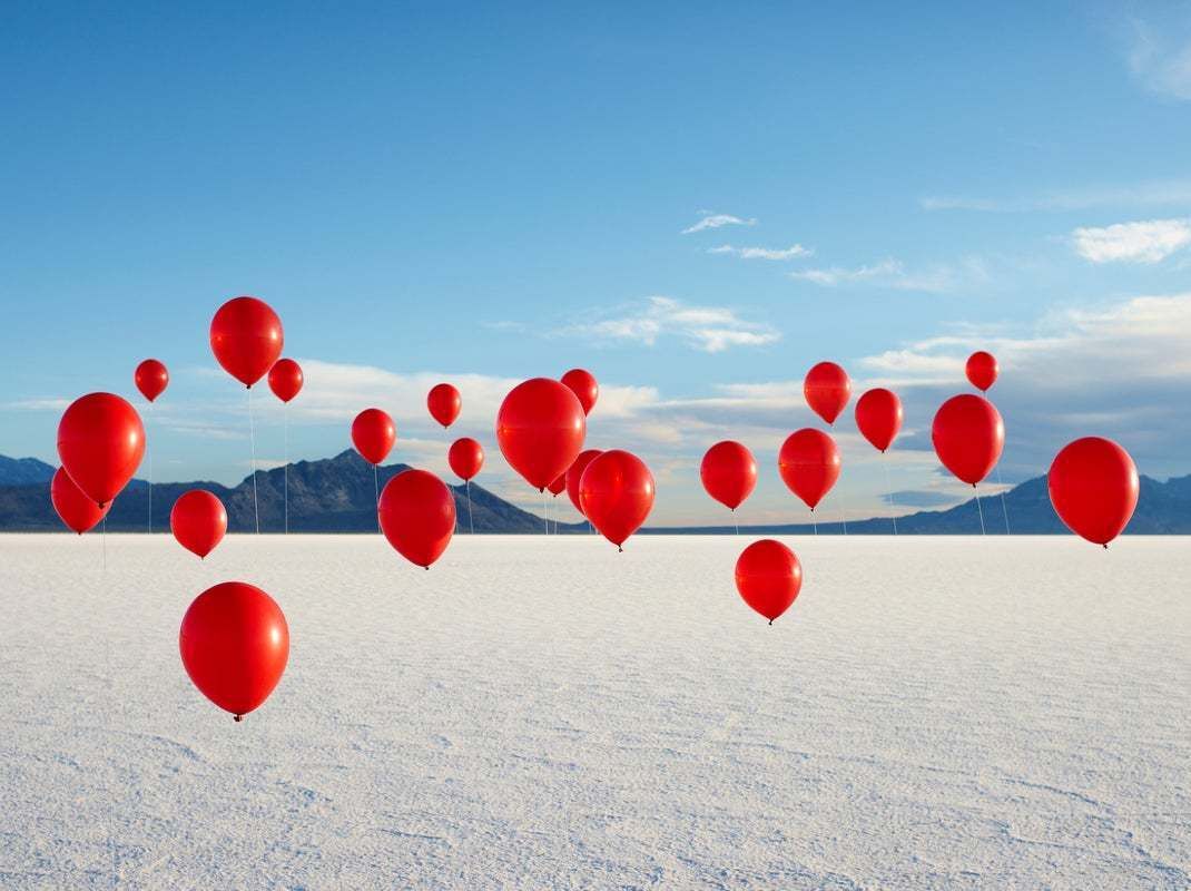 "Group Of Red Balloons On Salt Flats" By Andy Ryan