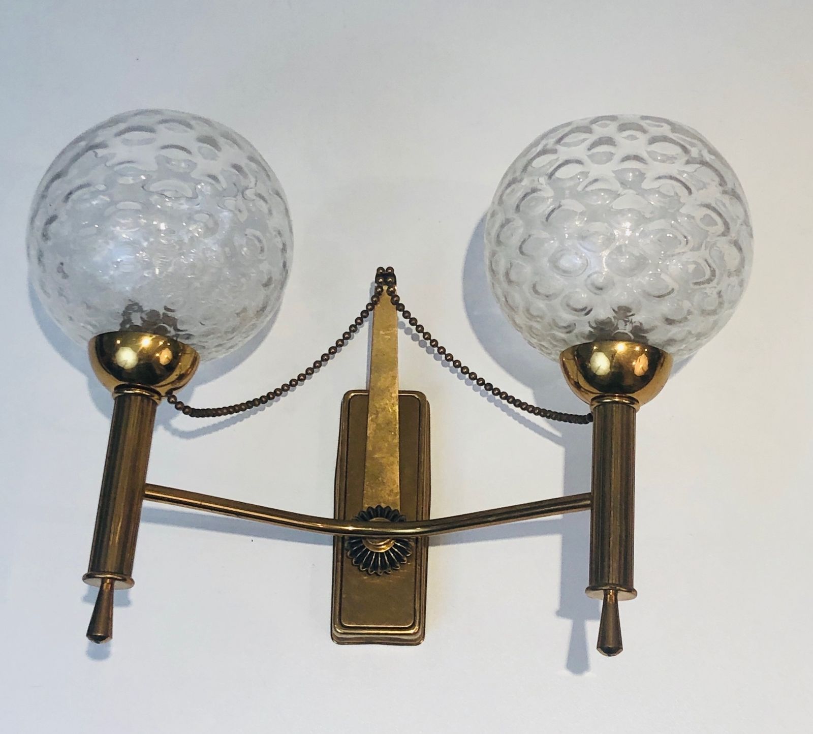 Pair Of Brass And Glass Ball Sconces. Around 1970 photo for sale