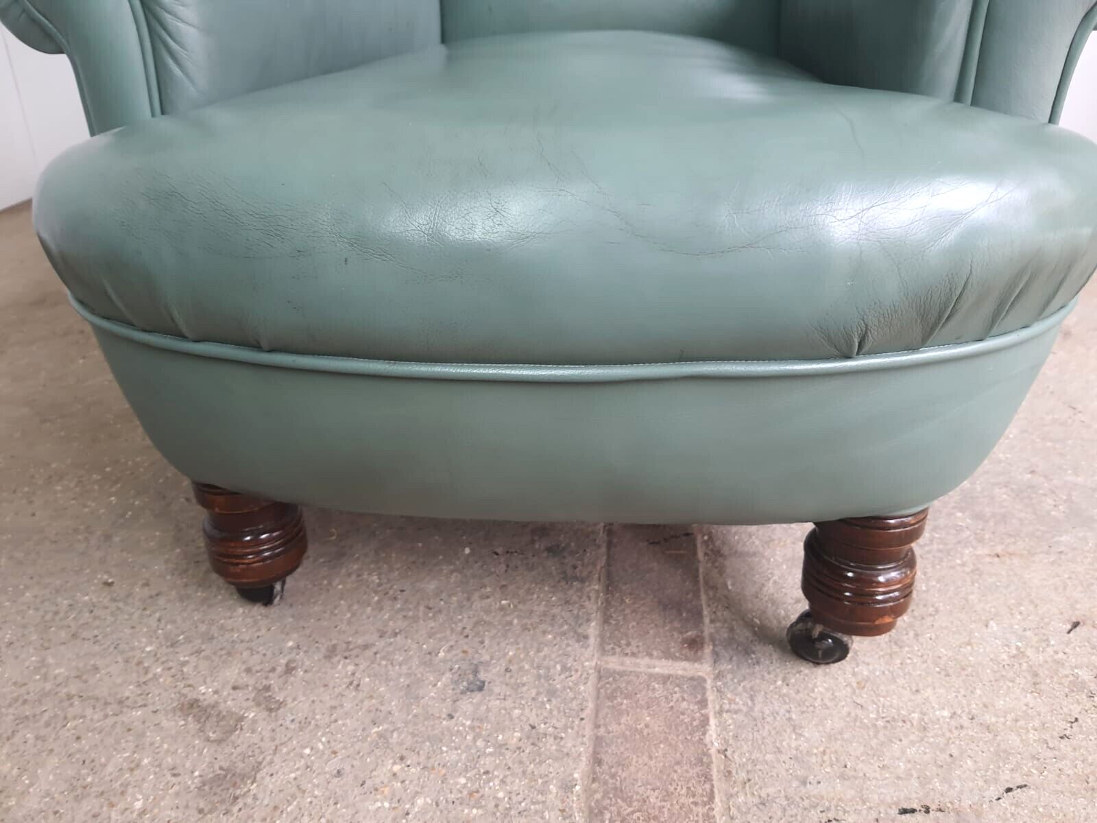 Antique Wing Back Green Leather Armchair Wood Legs Castors photo 360.0