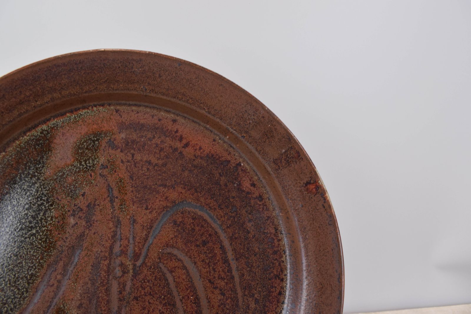 Studio Pottery; Iron Glaze Charger With Finger Wipe Decoration. photo for sale