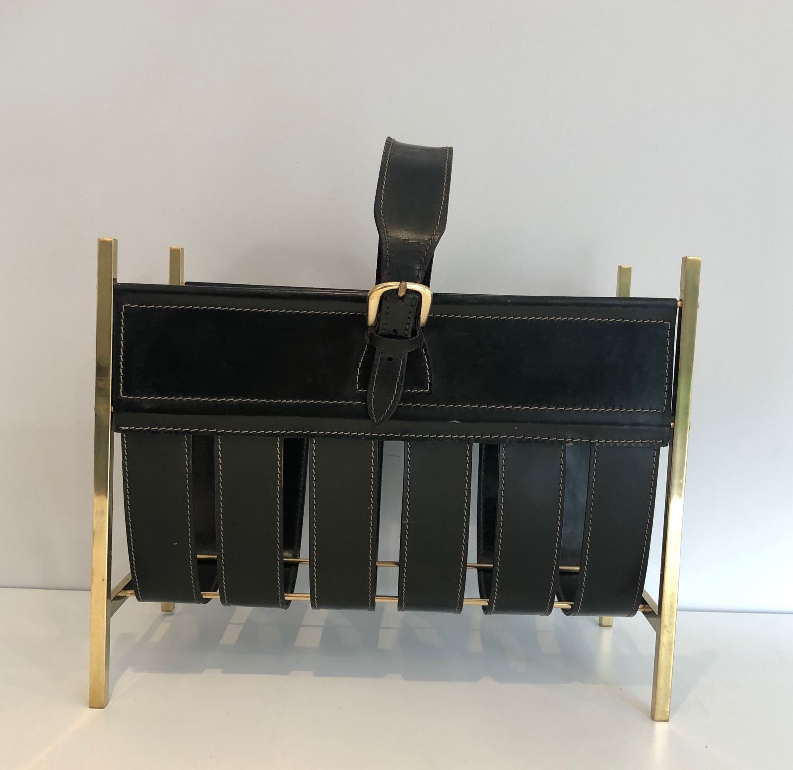 photo furniture Brass And Leather Magazine Rack Representing A Handbag. Work Of Jacques Adnet. Around 1940