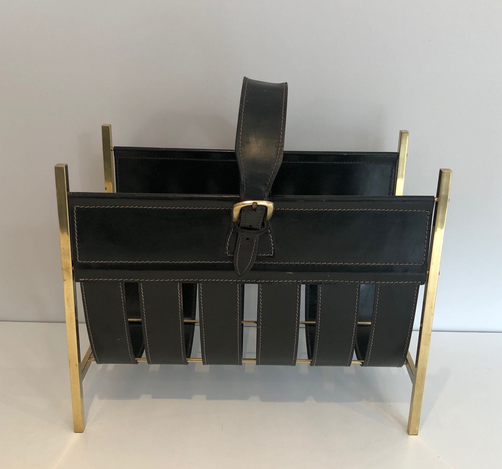 photo for sale Brass And Leather Magazine Rack Representing A Handbag. Work Of Jacques Adnet. Around 1940