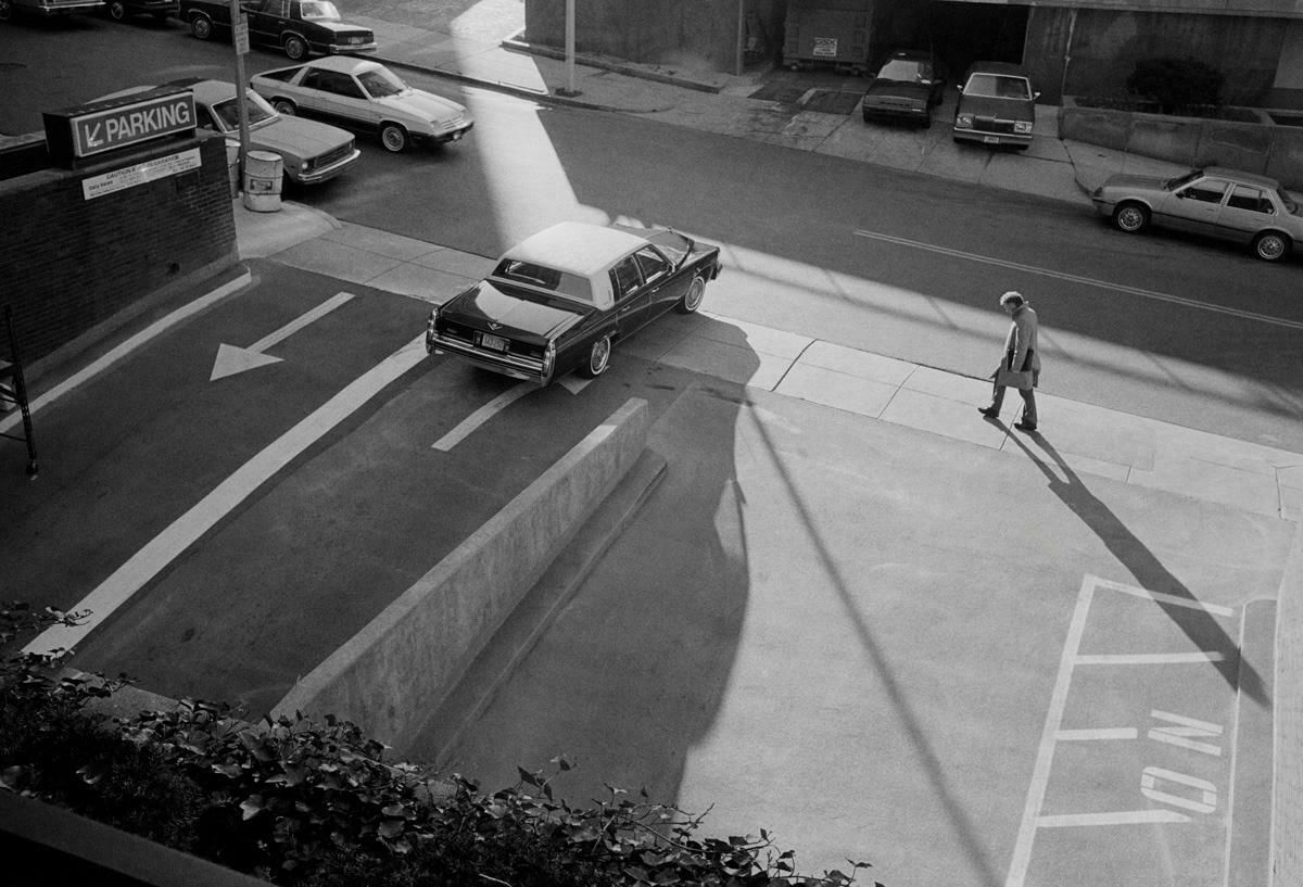 Michael Ormerod Man Walking Past Car Park   Classic Car, Cadillac, Street Photography C. 1989