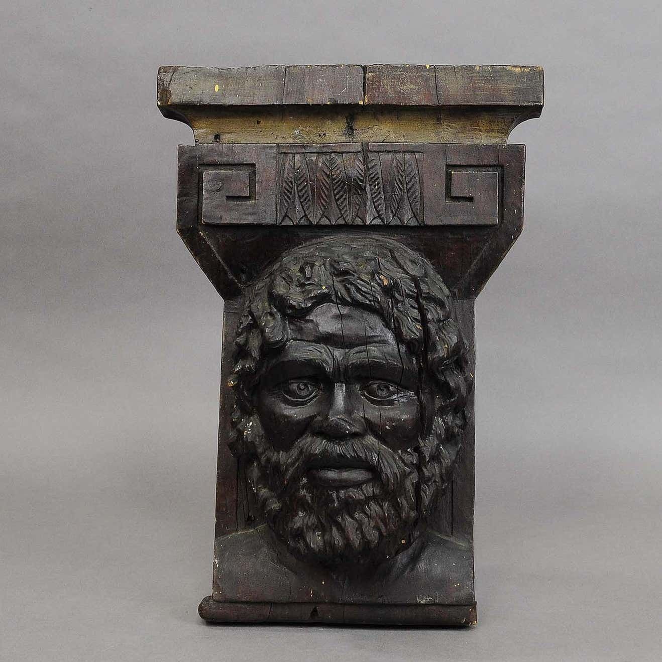 Wooden Sculpture Of A Masculine Face photo for sale