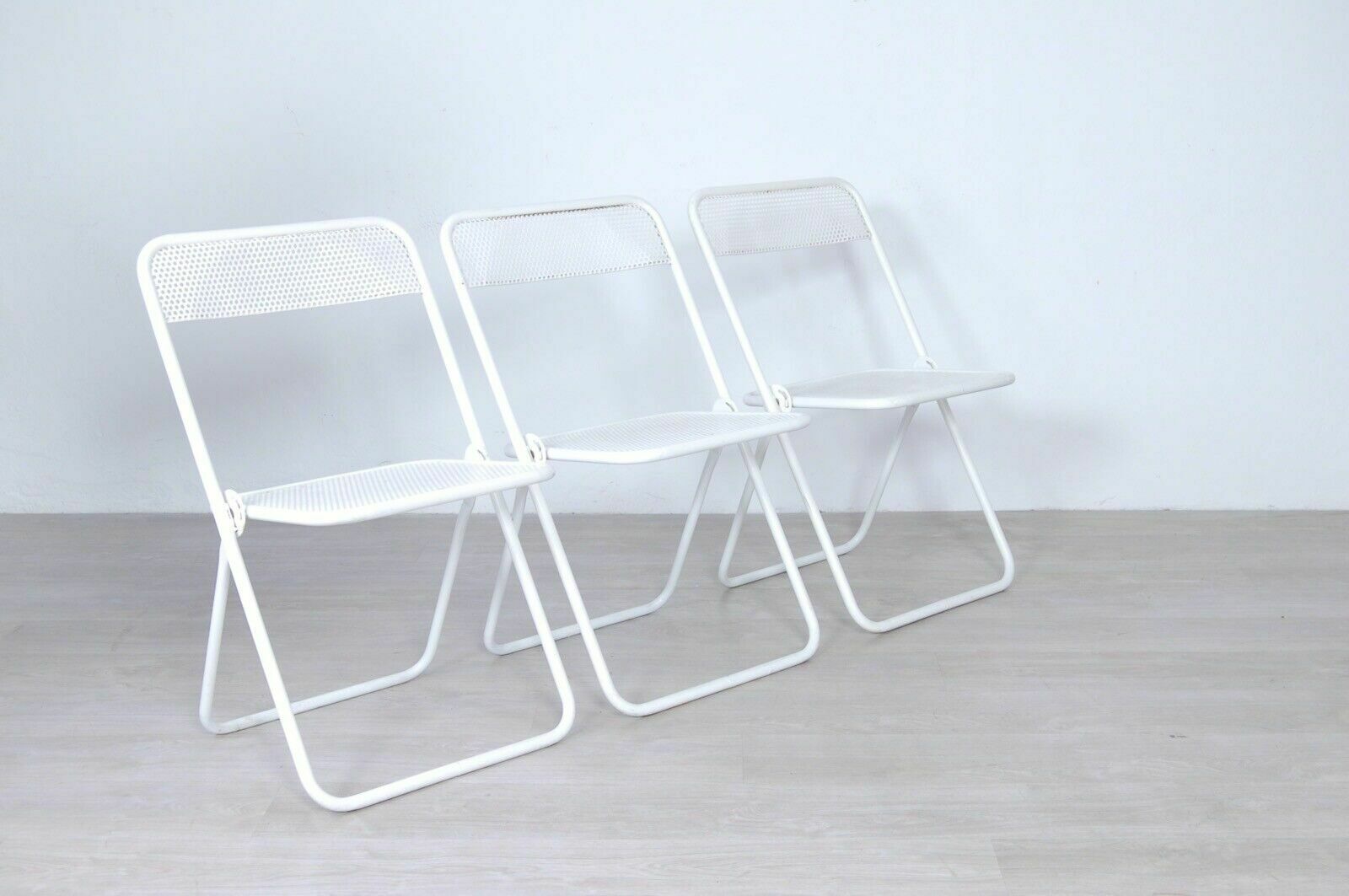 3 Vintage Folding Chairs In Perforated White Enamelled Iron Bar From The 60s And 70s