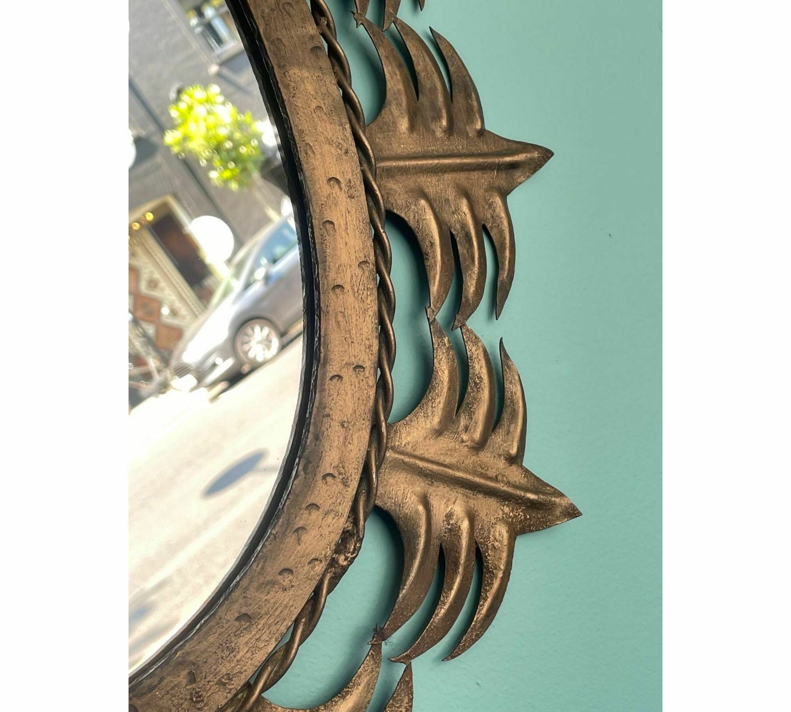 photo for sale A Spanish Sunburst 1950s Gilt Metal Oval Mirror With Ornate Edging.