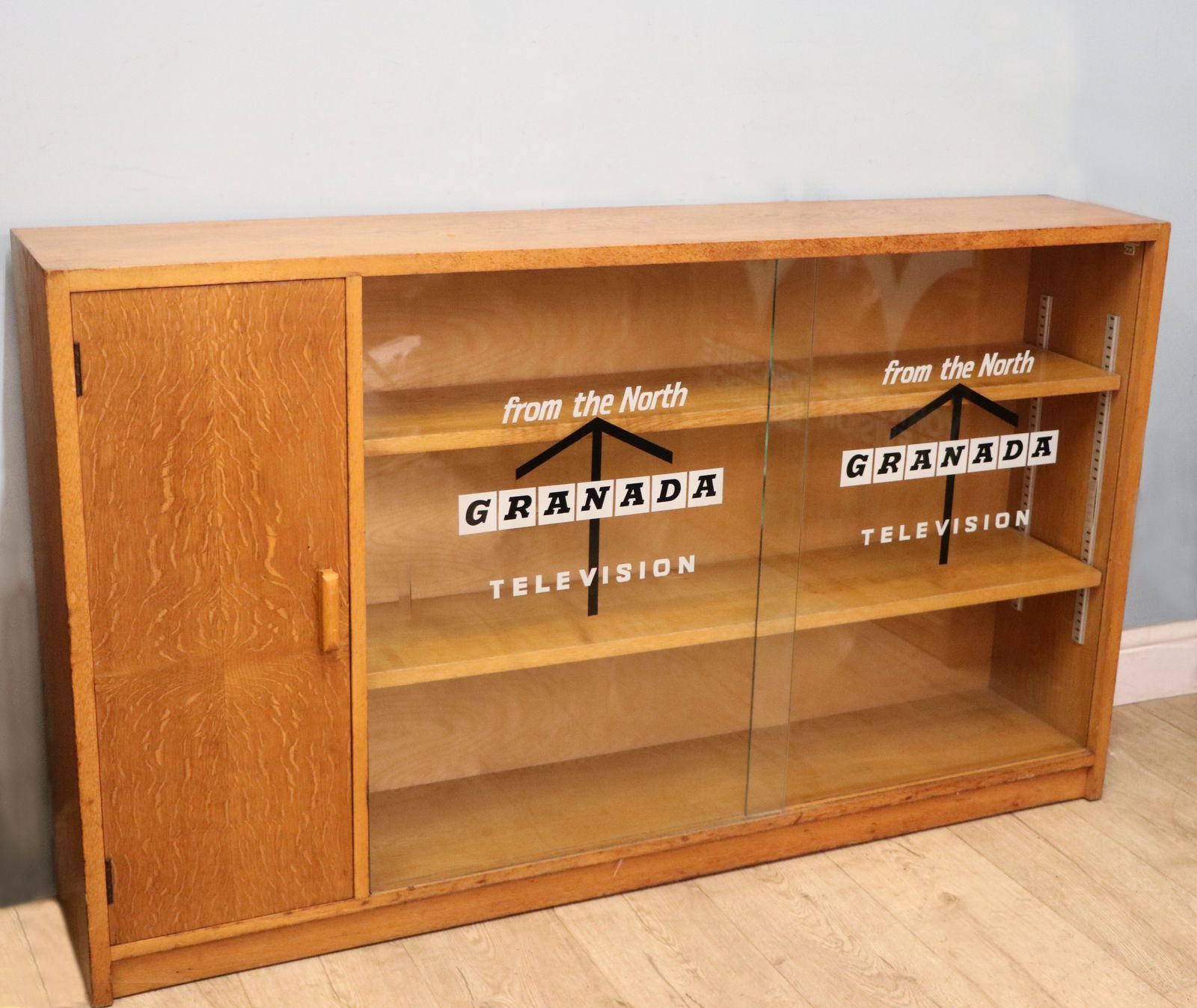 A Mid Century Light Oak Veneered Bookcase Later Sign Written For The Granada Television photo furniture