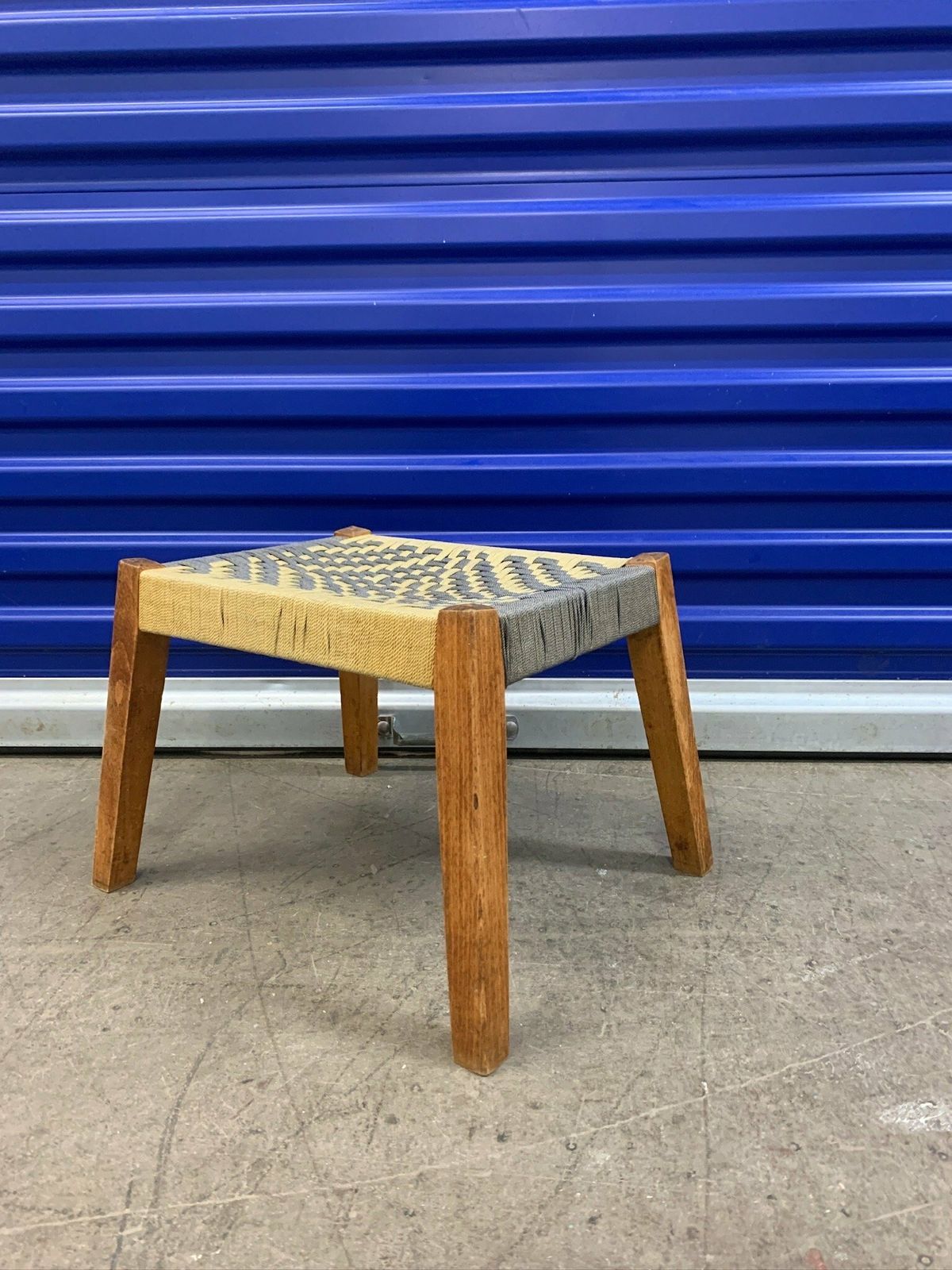 photo furniture Cute Little Footstool With Woven Rope Seat And Slanted Legs