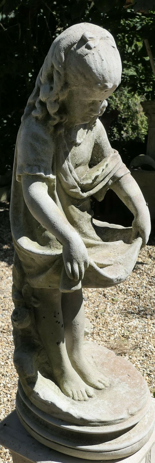 Statue Of A Girl Holding Out Her Apron photo vinterior