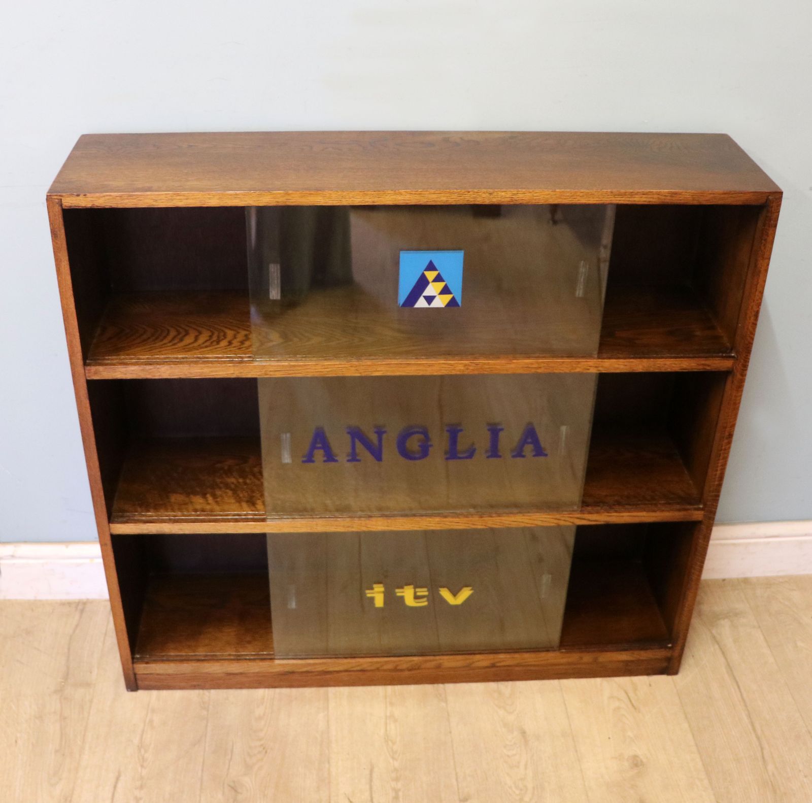 A Lovely Retro Mid Century Display Cabinet Later Sign Written For Anglia Television. photo furniture