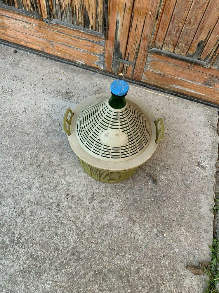 Mid Century Glass Demijohn In Plastic Basket photo for sale
