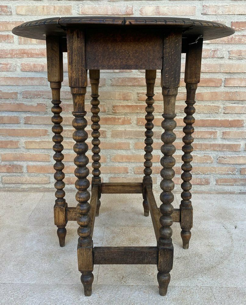 1682.0 Round Folding Center Oak Table With Carved Top And Solomonic Legs, 1940s photo