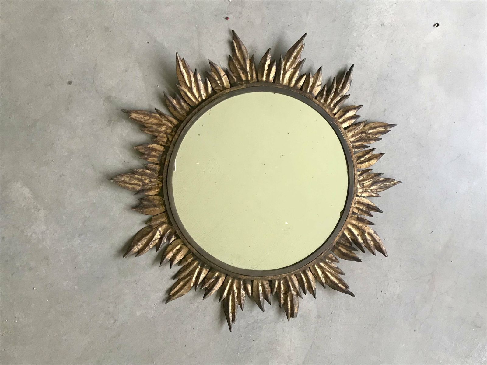 photo furniture Sun Mirror Decorated With Golden Leaves, Circa 1950.