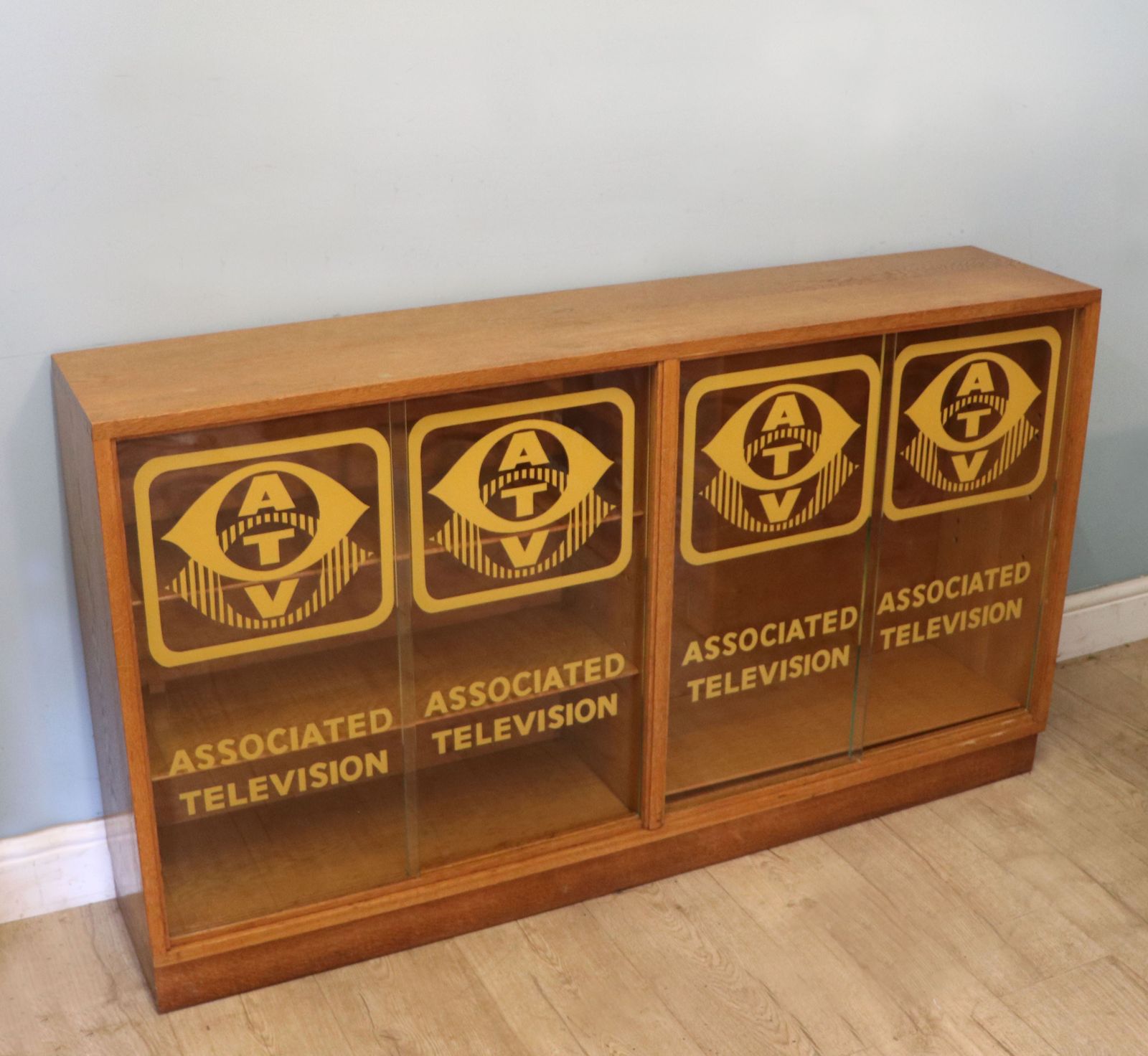 A Mid Century Oak Bookcase Cabinet, Later Sign Written For Associated Television. photo Furniture