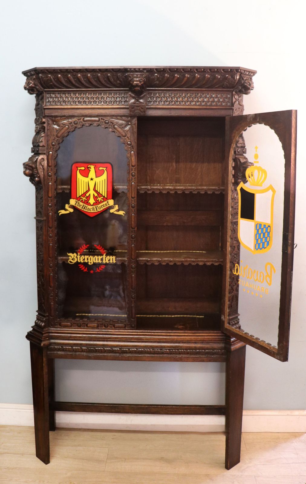 A Lovely Late 19th Heavily Carved Oak Bookcase Cabinet On Stand, Later Sign Written With A Selection Of German Beer Related Emblems. photo furniture