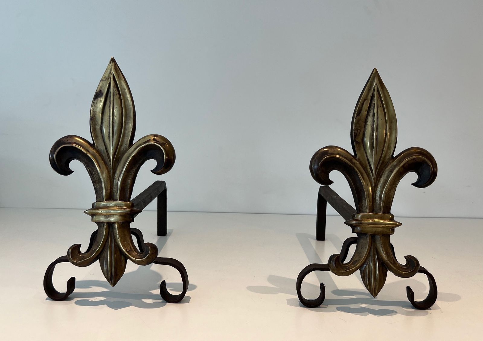 Pair Of Bronze And Wrought Iron Andirons Representing A Fleurs De Lys