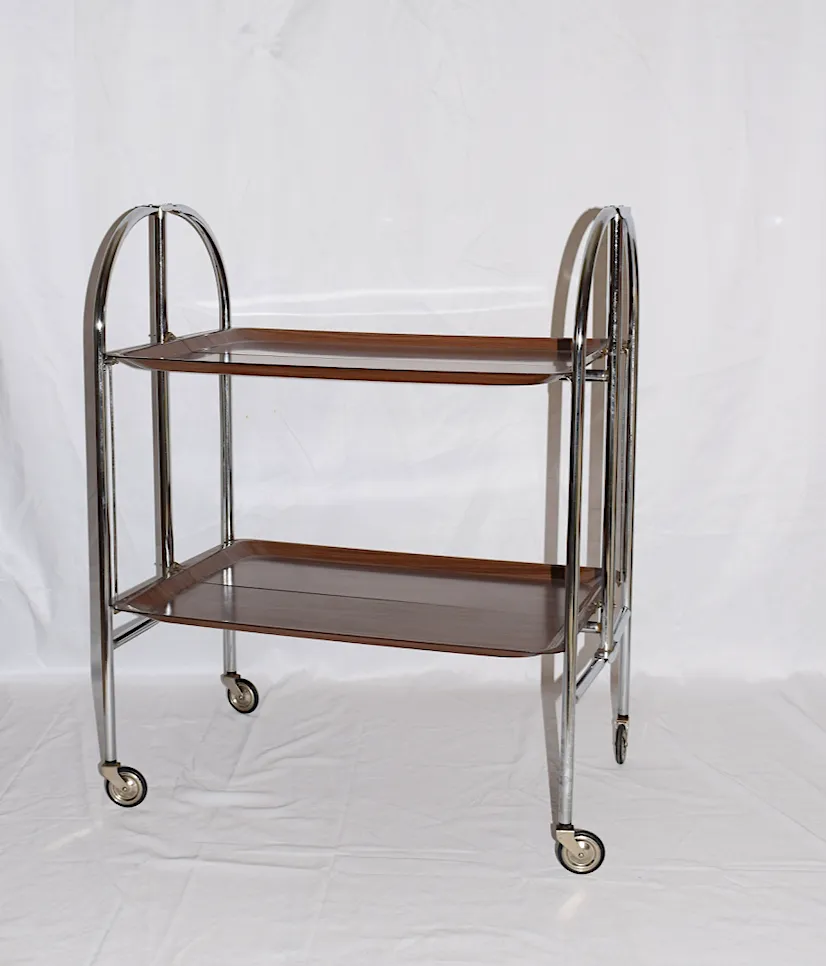 A Mid Century Bremshey & Co German Dinette Trolley. Made Of Chrome & Lamented Wood. It Folds Into A Smaller Frame. Attribution Mark On The Wheels.