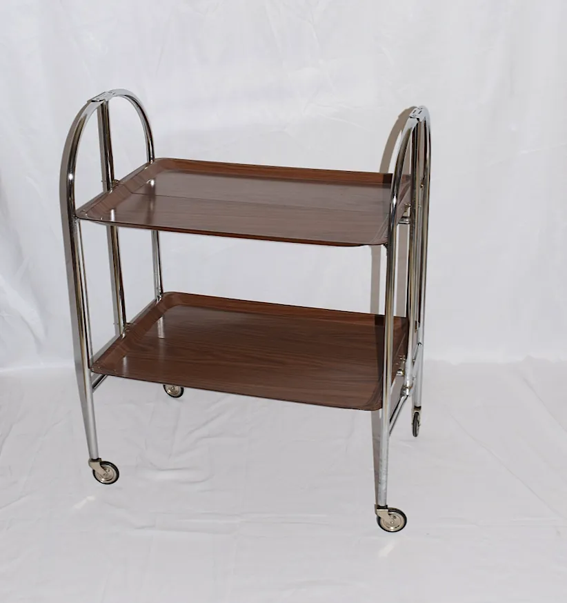 A Mid Century Bremshey & Co German Dinette Trolley. Made Of Chrome & Lamented Wood. It Folds Into A Smaller Frame. Attribution Mark On The Wheels. photo furniture