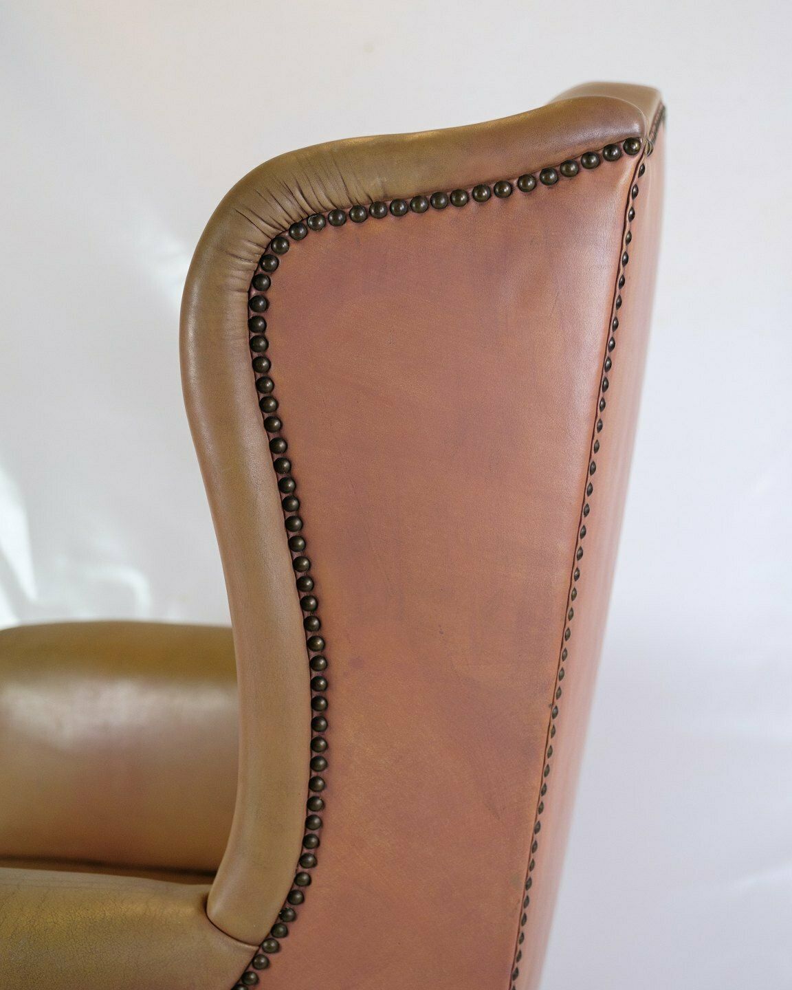 photo furniture Antique High Ear Flap Chair  In Brown Studded Leather From 1920s
