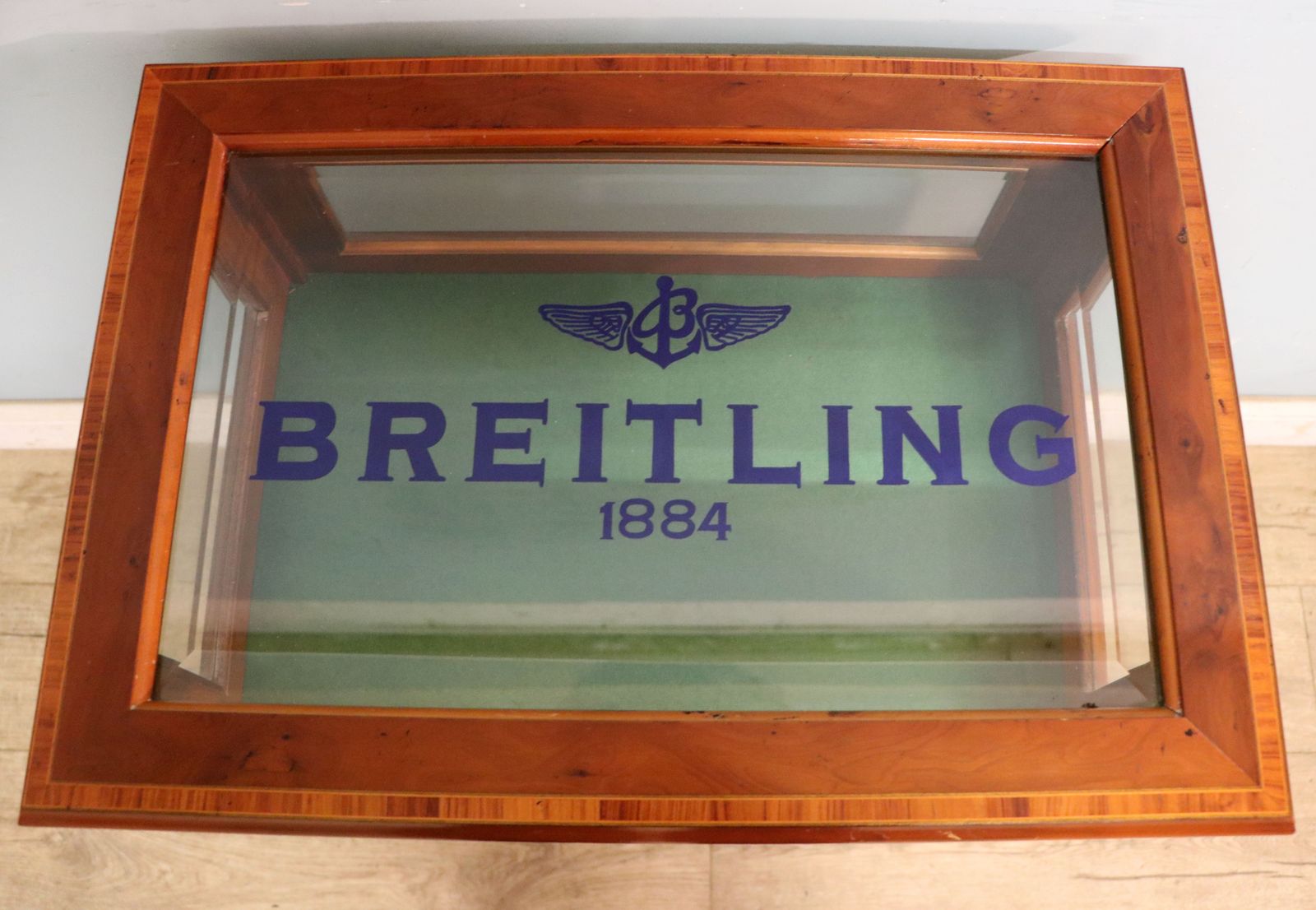 A Lovely Yew Wood Veneered Bijouterie Display Table, Later Sign Written For Breitling Watches. photo for sale