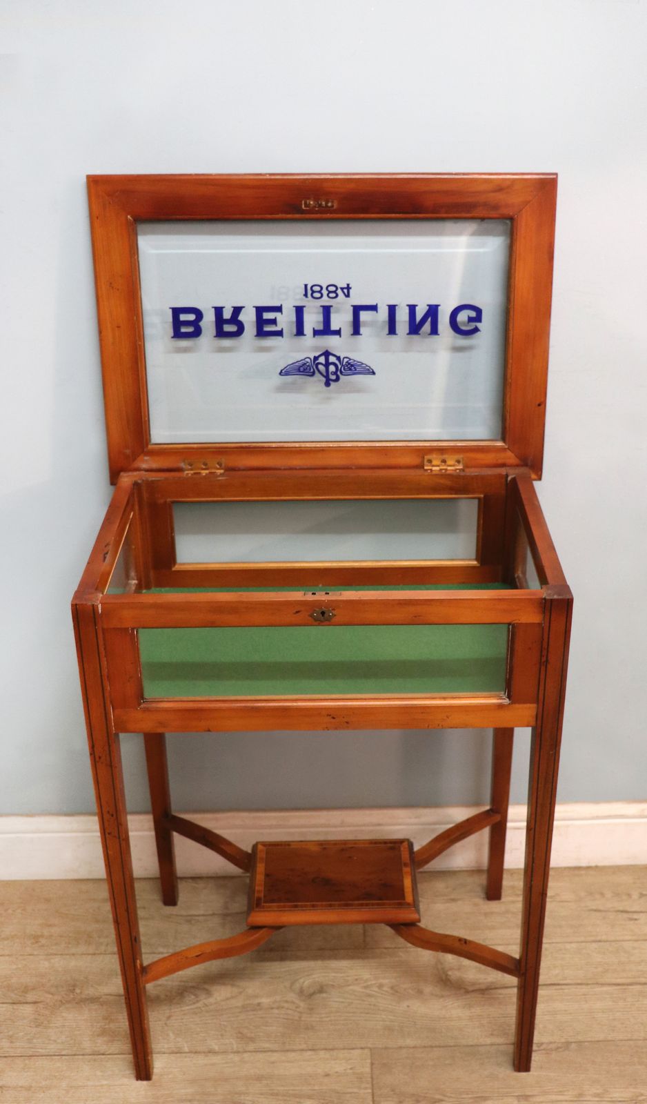 A Lovely Yew Wood Veneered Bijouterie Display Table, Later Sign Written For Breitling Watches. photo Furniture