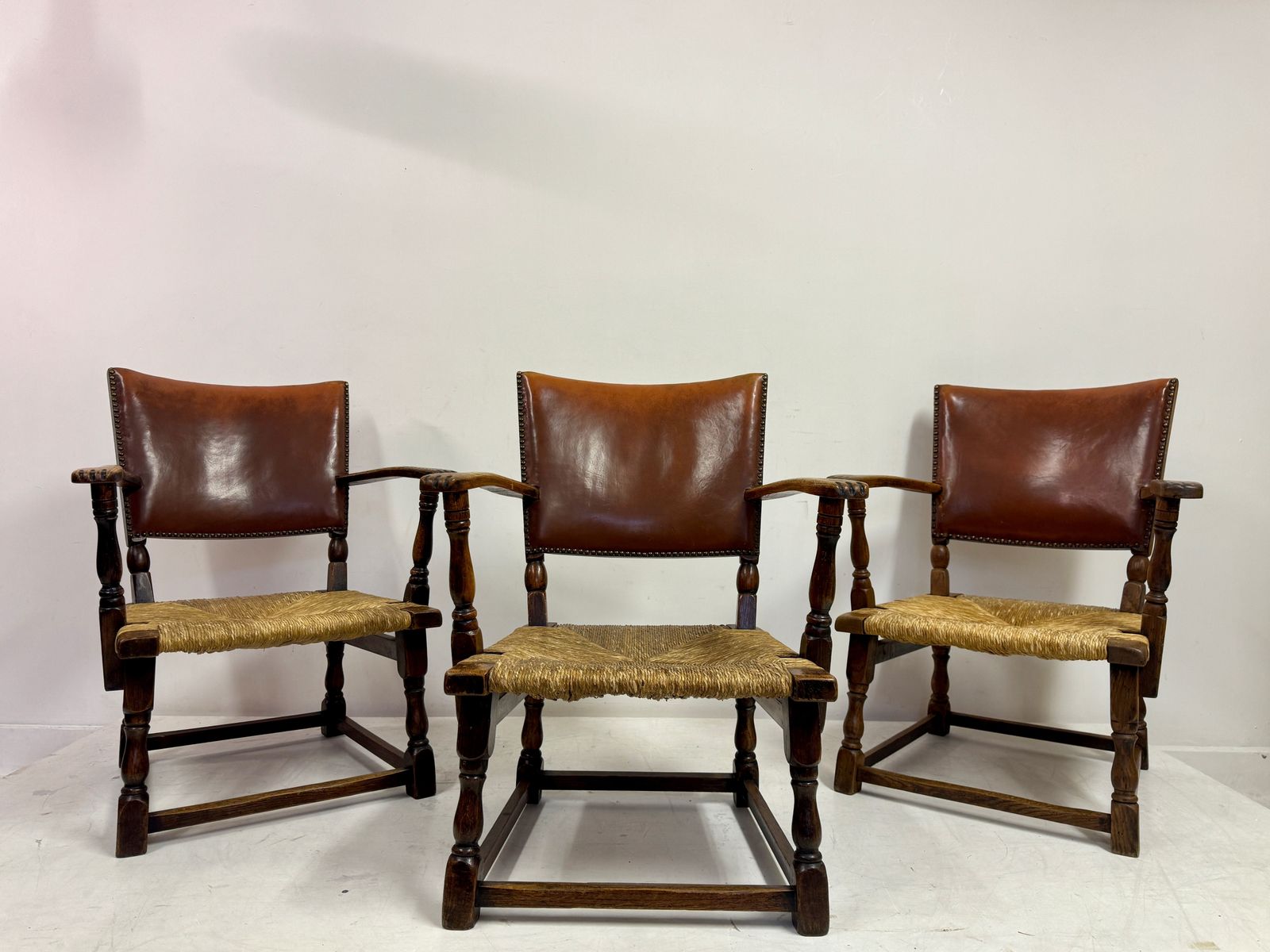 photo furniture Set Of Three Oak Armchairs With Rush And Leather Seats