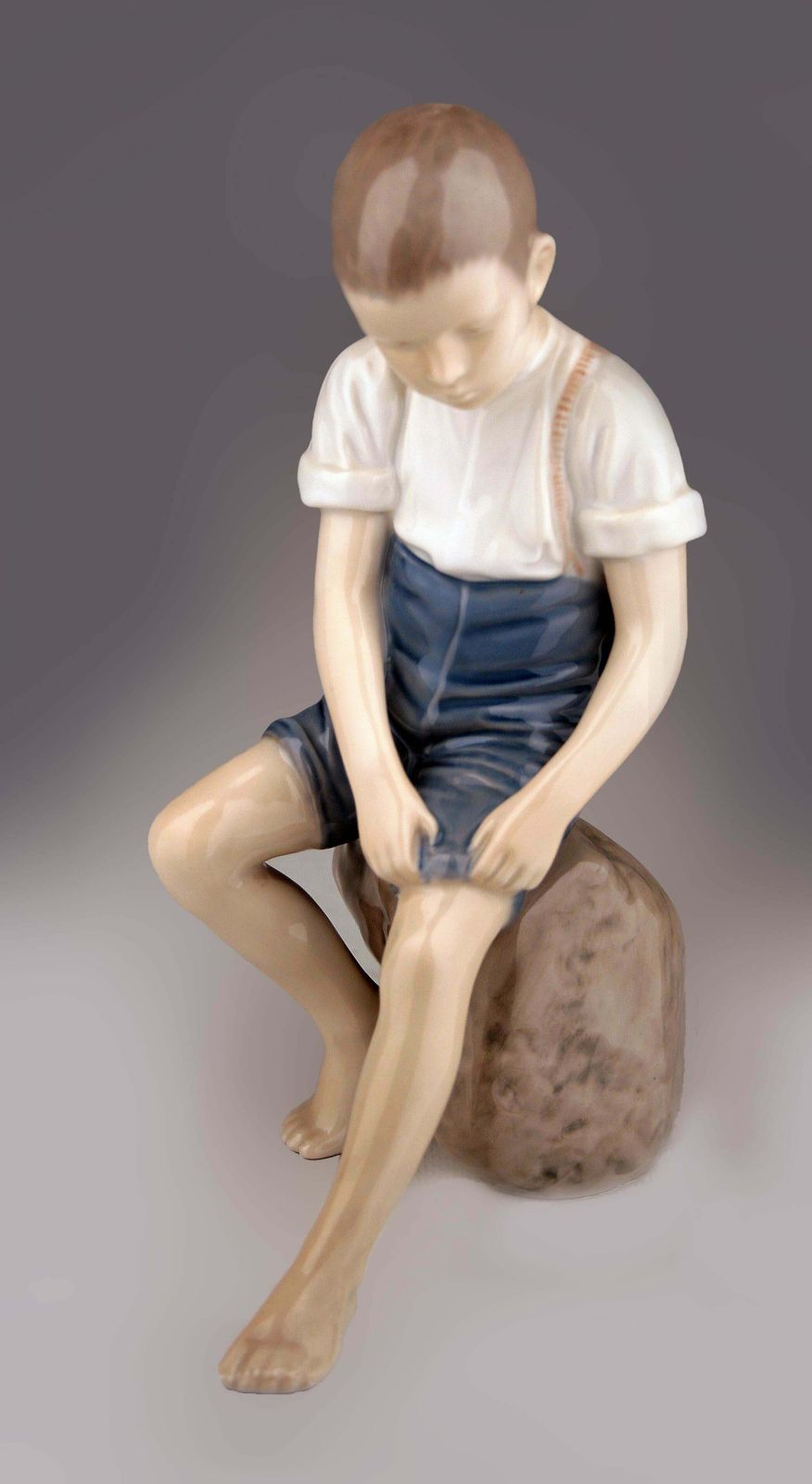 Mid 20th Century Scandinavian Modern Glazed Porcelain Sculpture Of A Boy Sitting On A Rock By Danish Company Bing & Grøndahl photo furniture