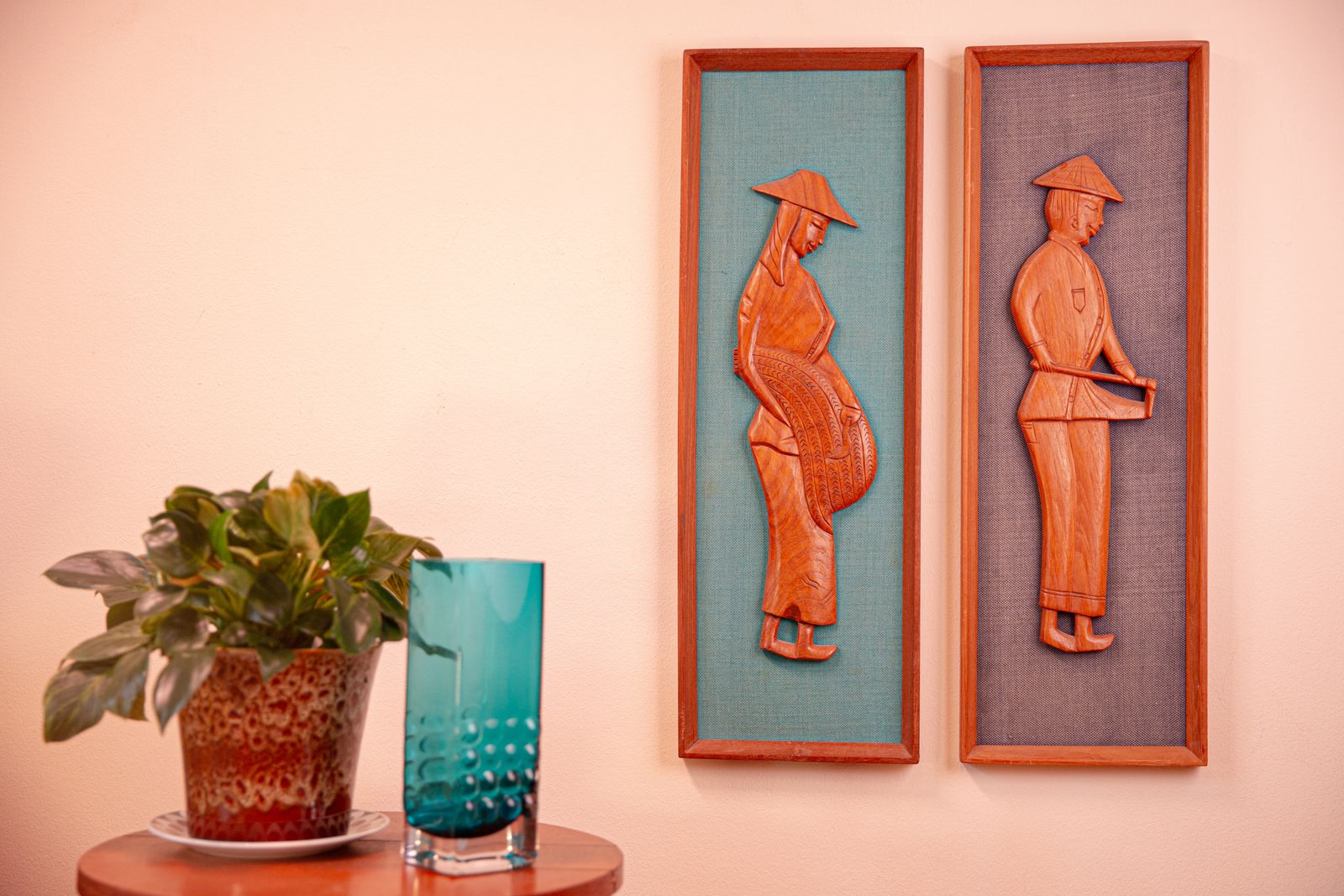 Pair Of Mid Century South East Asian Hardwood Wall Sculptures On Blue Canvas In Teak Frames