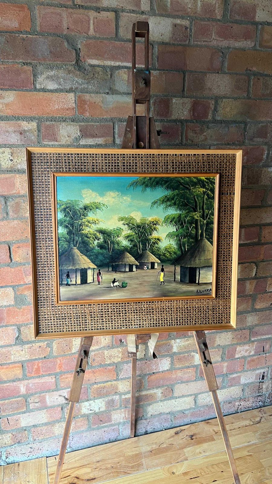 Vintage Framed Oil On Canvas Painting Depicting An African Village Scene