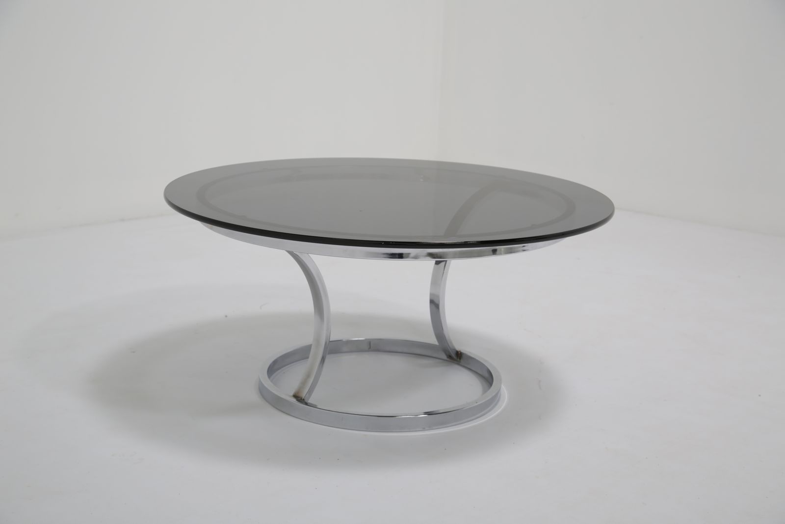 photo furniture Mid Century Chrome And Smoked Glass Coffee Table, USA, 1970s.